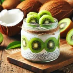 A glass jar filled with creamy coconut chia pudding, layered with fresh kiwi slices, and topped with chia seeds. Placed on a wooden surface with coconuts and whole kiwis in the background.
